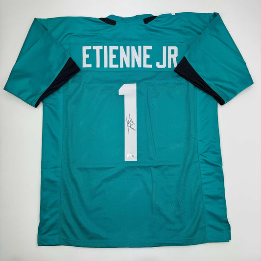 Autographed/Signed Travis Etienne Jr. Jacksonville Teal Football Jersey Beckett BAS COA